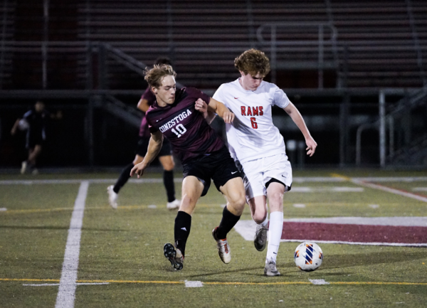 Recovered and rested: Senior Jake Frischmann pushes past a Henderson player for the ball. Frischmann has been on the team since freshman year but took multiple hiatuses due to his injuries.